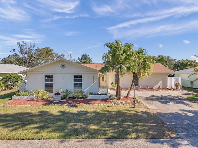 single story home featuring fence and a front lawn