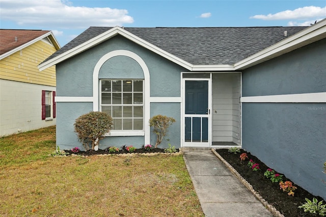 doorway to property featuring a lawn