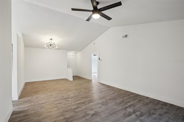 unfurnished living room with ceiling fan with notable chandelier, hardwood / wood-style flooring, and lofted ceiling