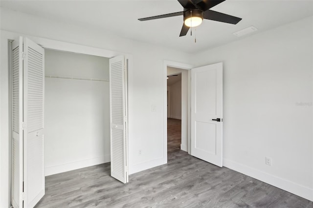 unfurnished bedroom with ceiling fan, a closet, and light hardwood / wood-style flooring