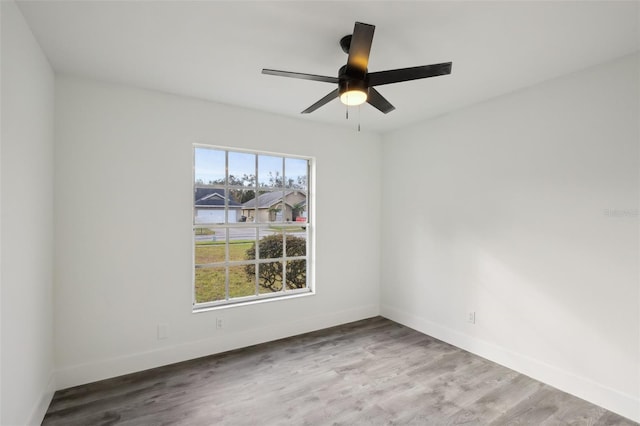 empty room with ceiling fan and wood-type flooring