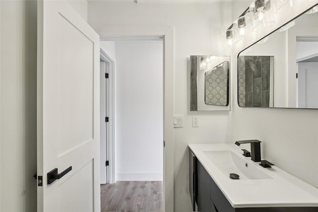 bathroom with hardwood / wood-style floors and vanity