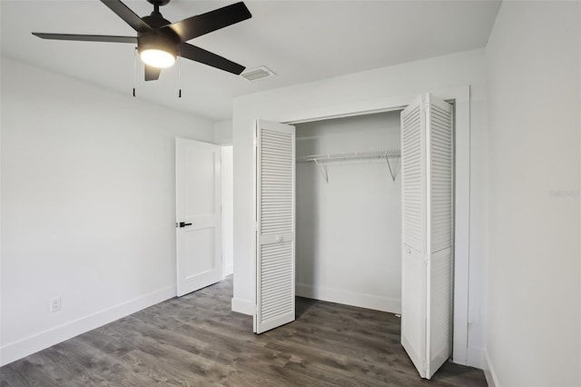 unfurnished bedroom featuring dark hardwood / wood-style flooring, a closet, and ceiling fan