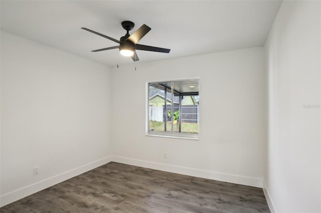 spare room with ceiling fan and dark hardwood / wood-style floors