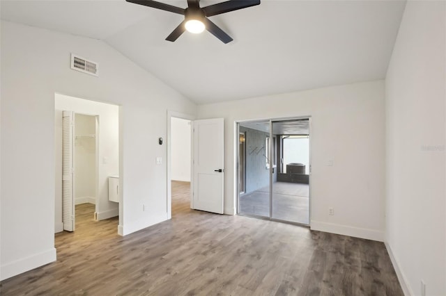 unfurnished bedroom with a walk in closet, ceiling fan, access to exterior, wood-type flooring, and a closet