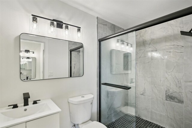 bathroom with vanity, toilet, and walk in shower