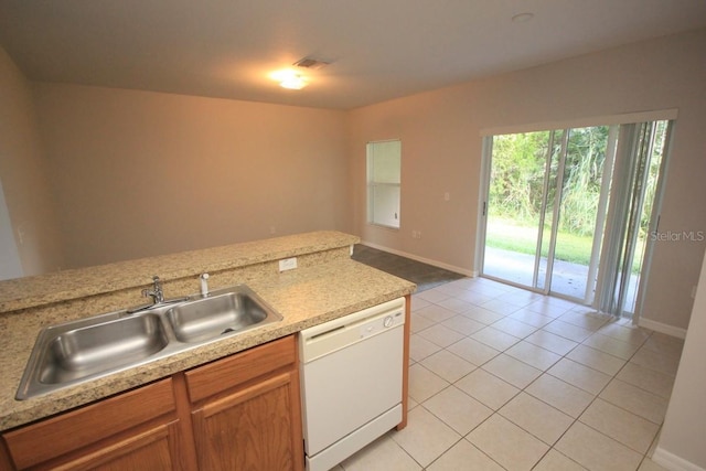 kitchen featuring dishwasher, light tile patterned floors, and sink