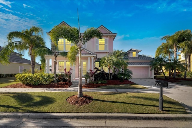 view of front of house featuring a garage and a front lawn