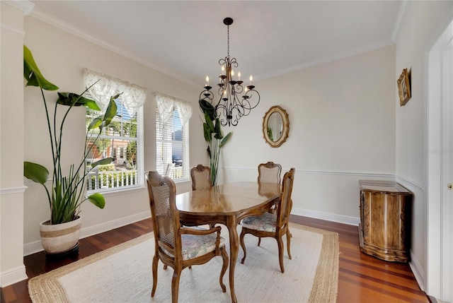 dining space featuring dark hardwood / wood-style floors, an inviting chandelier, and crown molding