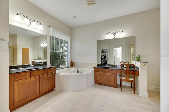 bathroom featuring shower with separate bathtub, vanity, and tile patterned floors