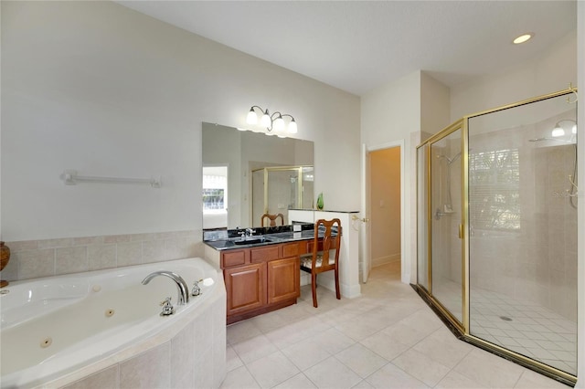 bathroom with plus walk in shower, vanity, and tile patterned flooring