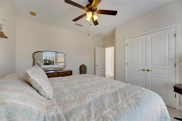 carpeted bedroom featuring a closet and ceiling fan