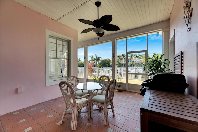 sunroom / solarium featuring ceiling fan