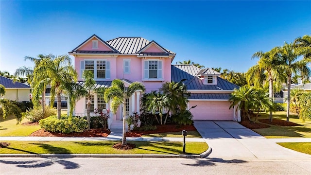620 Mirabay Blvd, Apollo Beach, FL 33572 - view of front of house with a standing seam roof, a metal roof, concrete driveway, and a garage