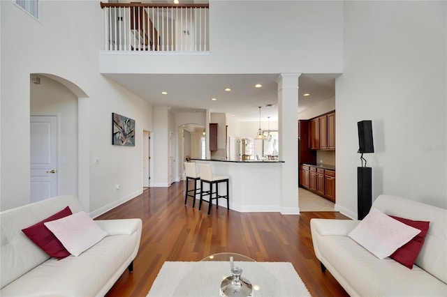 620 Mirabay Blvd, Apollo Beach, FL 33572 - living area featuring arched walkways, wood finished floors, a high ceiling, and recessed lighting