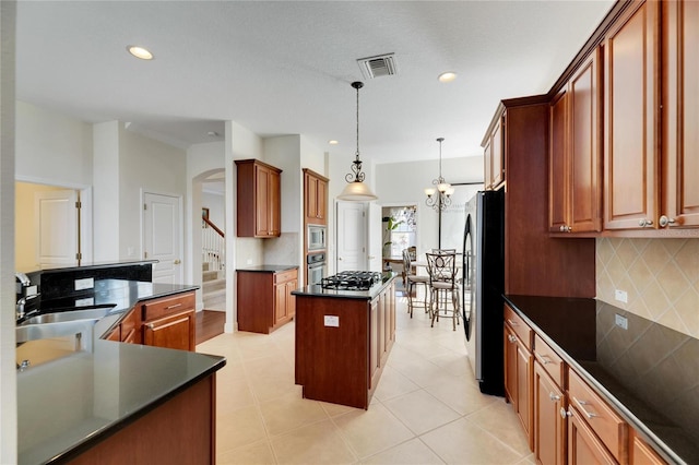 620 Mirabay Blvd, Apollo Beach, FL 33572 - kitchen with a center island, stainless steel appliances, decorative backsplash, dark countertops, and recessed lighting