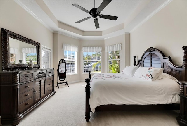 620 Mirabay Blvd, Apollo Beach, FL 33572 - bedroom featuring light colored carpet, a raised ceiling, crown molding, and a ceiling fan