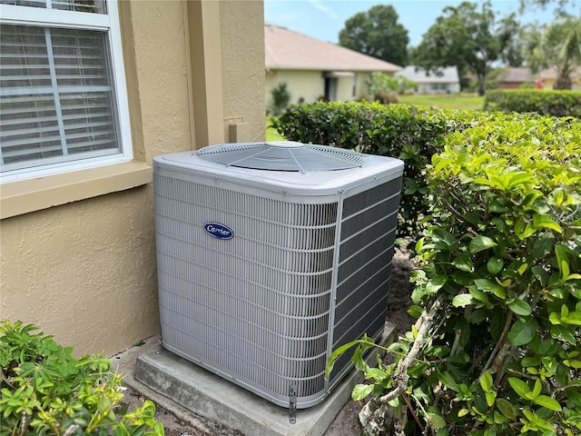 3259 Hilary Cir Unit 1A, Palm Harbor, FL 34684 - exterior view of a central AC unit and stucco siding