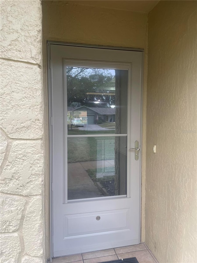 3259 Hilary Cir Unit 1A, Palm Harbor, FL 34684 - view of exterior entry with stucco siding