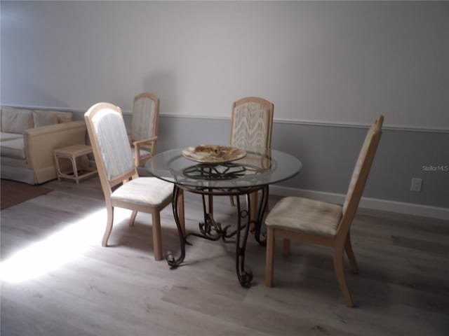 3259 Hilary Cir Unit 1A, Palm Harbor, FL 34684 - dining area with wood finished floors and baseboards