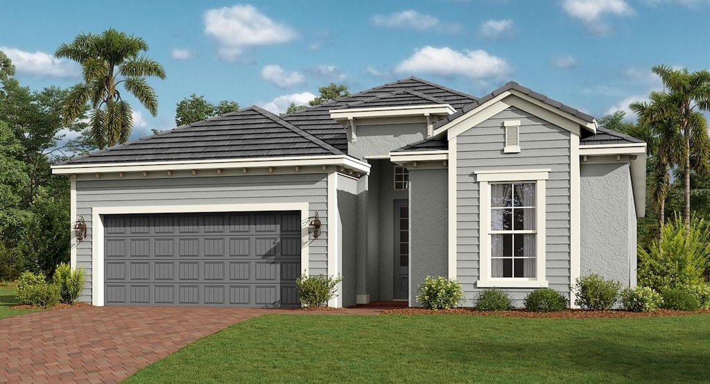 view of front of house featuring a garage and a front lawn