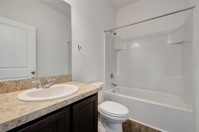 full bathroom with hardwood / wood-style floors, vanity, toilet, and bathtub / shower combination