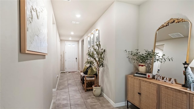 corridor with light tile patterned floors