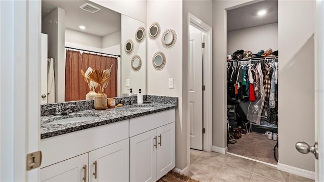 bathroom with tile patterned floors, a shower with curtain, and vanity