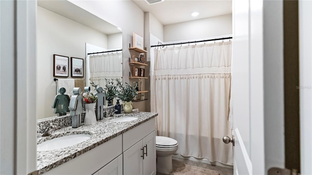 bathroom featuring vanity and toilet