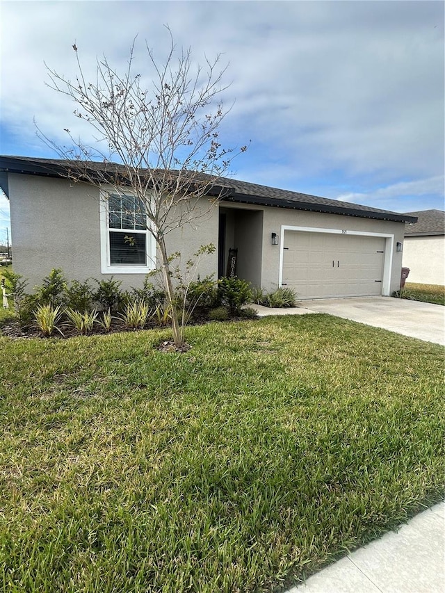 single story home with a garage and a front lawn