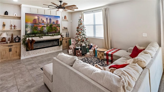 living room with built in shelves, light tile patterned floors, and ceiling fan