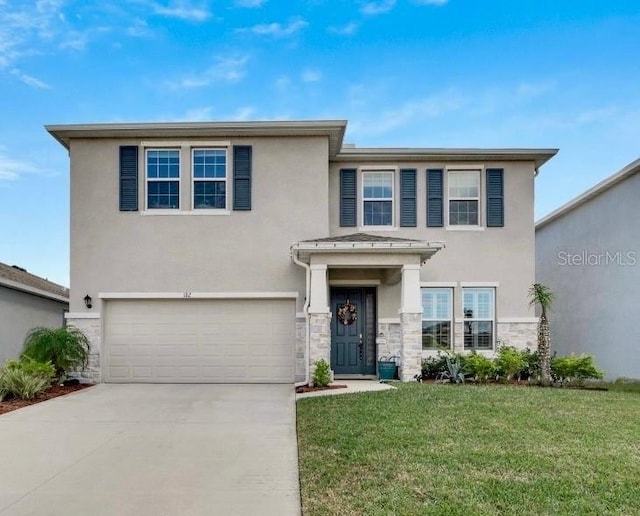 view of front facade featuring a front lawn and a garage