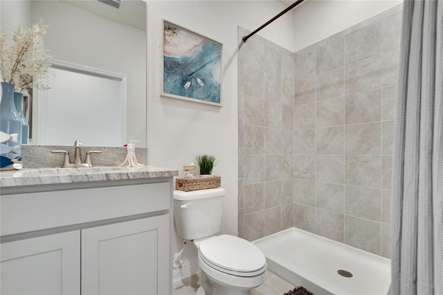 bathroom with vanity, toilet, and walk in shower