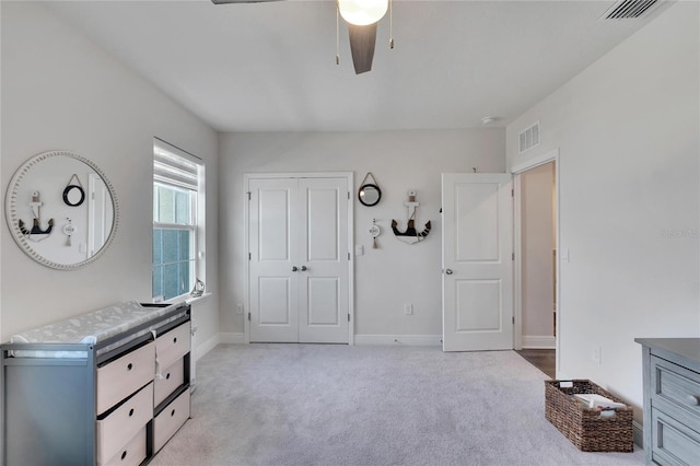 bedroom with ceiling fan and light carpet