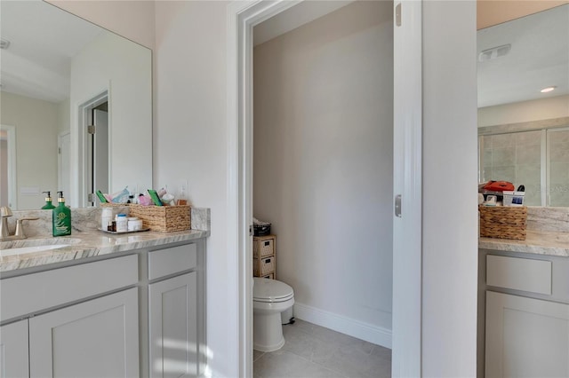 bathroom with tile patterned floors, vanity, and toilet