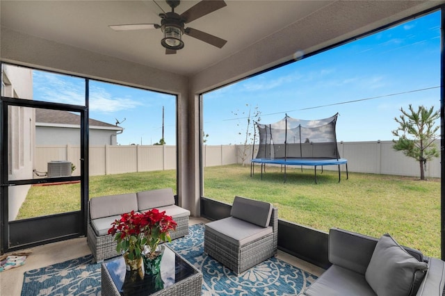 sunroom featuring ceiling fan