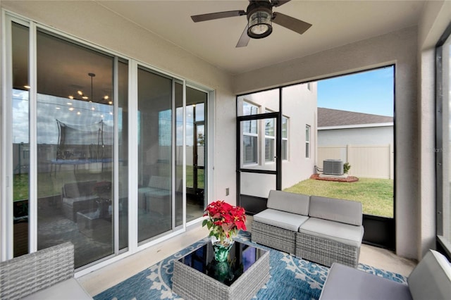 sunroom featuring ceiling fan