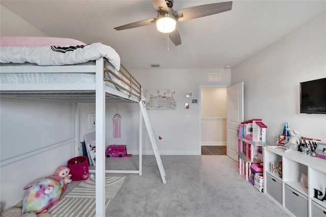 bedroom featuring ceiling fan and carpet