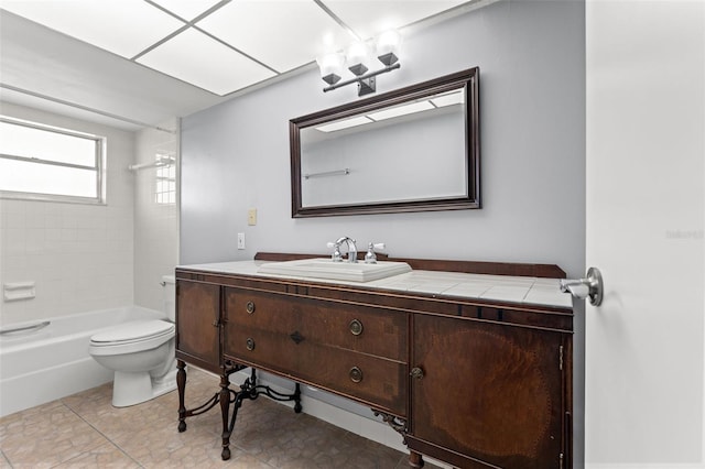 full bathroom featuring toilet, vanity, and tiled shower / bath