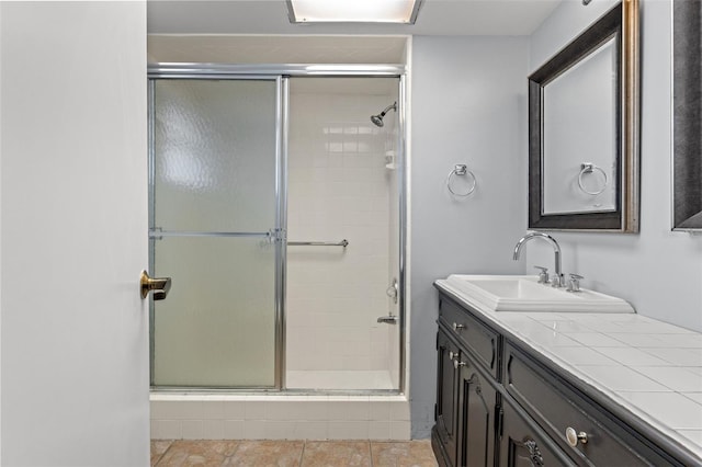 bathroom with vanity and a shower with door