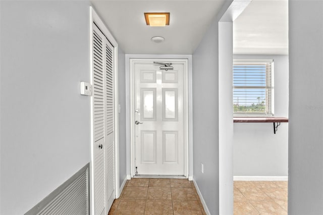 entryway featuring light tile patterned floors