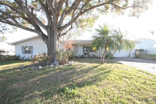 single story home with a garage and a front yard