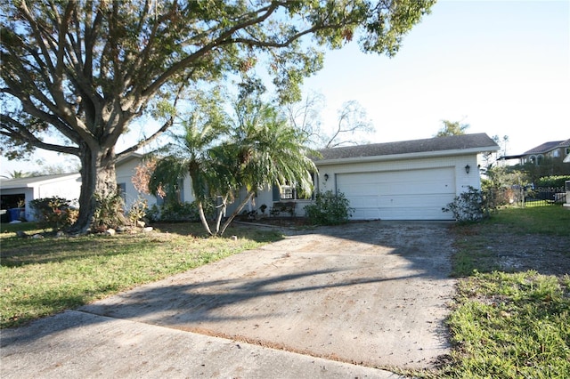 ranch-style home with a garage and a front yard