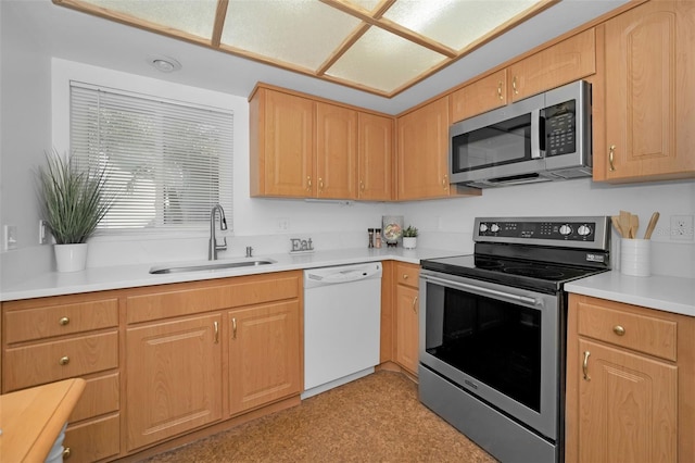 kitchen featuring light brown cabinets, sink, and stainless steel appliances