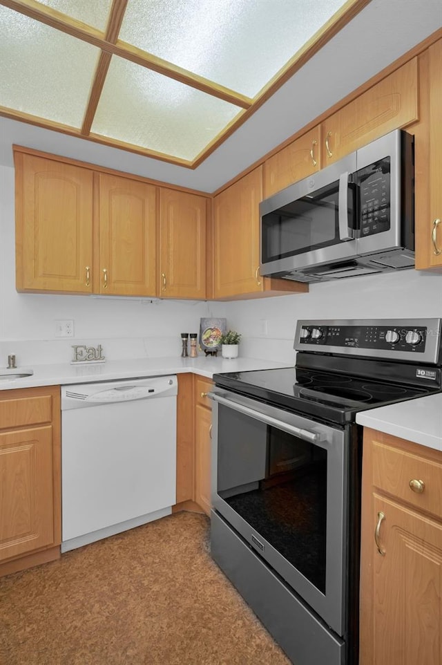 kitchen featuring sink, stainless steel appliances, and light brown cabinetry