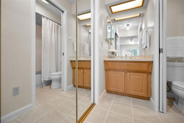 full bathroom featuring vanity, a skylight, toilet, and shower / tub combo with curtain