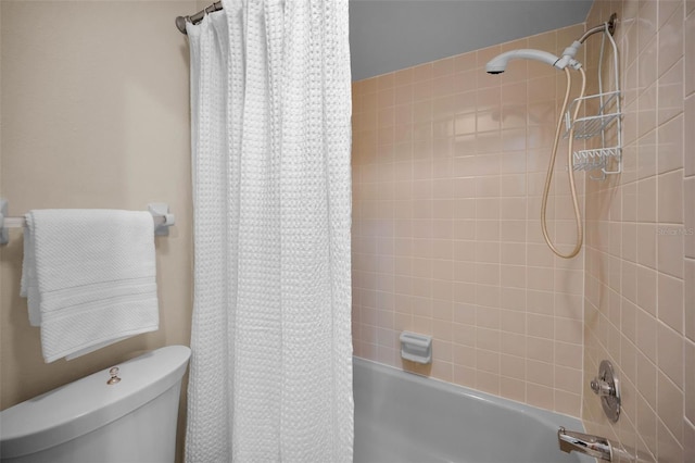 bathroom with shower / bath combo and toilet