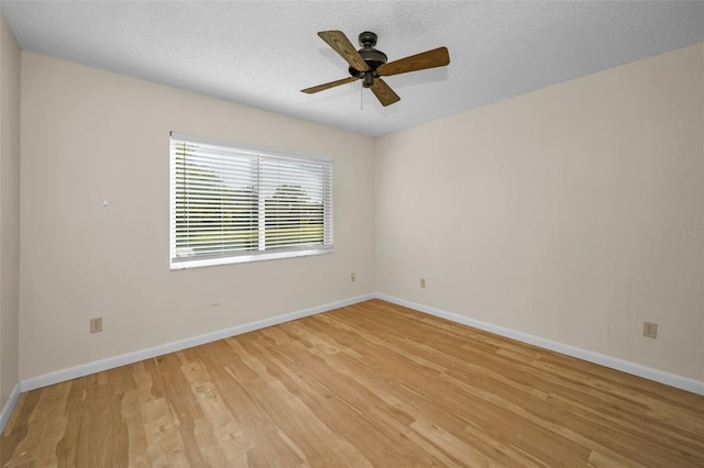 spare room with a textured ceiling, light hardwood / wood-style flooring, and ceiling fan