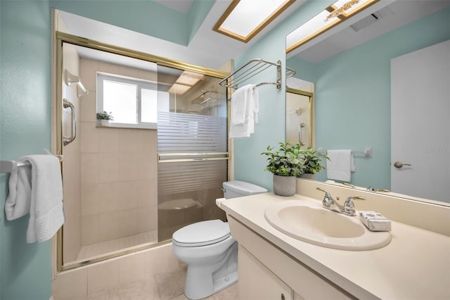 bathroom with tile patterned flooring, vanity, toilet, and walk in shower