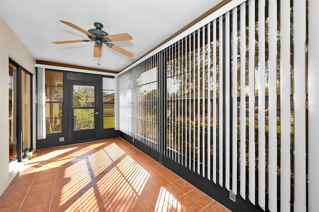 unfurnished sunroom featuring ceiling fan